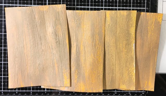 Two layers of paint on embossed cardboard to mimic wood