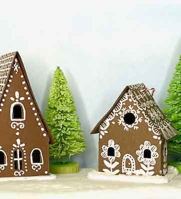 Two tiny Christmas paper house ornaments in brown cardstock