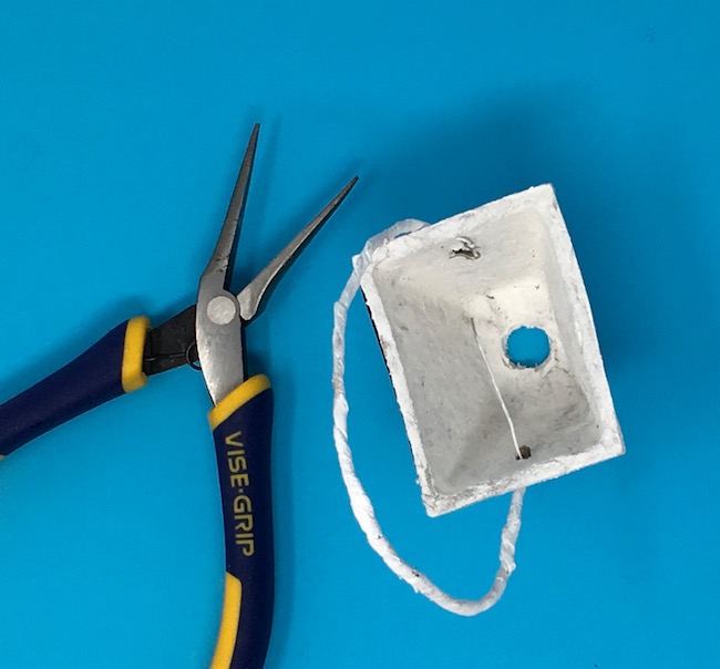 Use needlenose pliers to curl wire for handle on peat pot basket