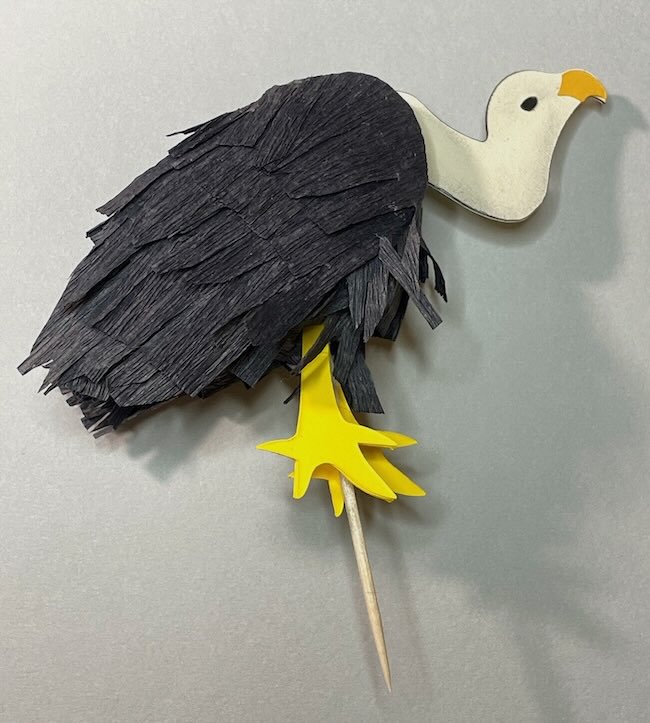 Vulture cake topper on grey background
