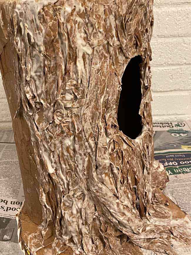 apply wrinkled twisted paper to mimic bark paper mache tree stump