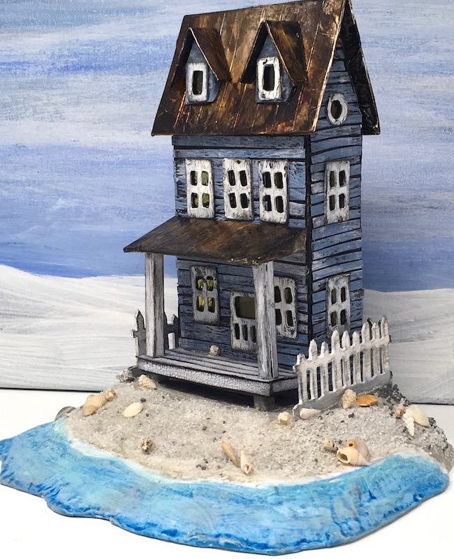 Sea Worn beach Putz house with blue sky background