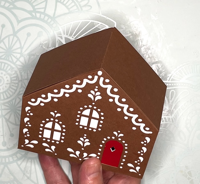 completed gingerbread house gift box without roof pieces in place