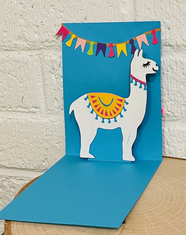 white llama on blue pop-up card