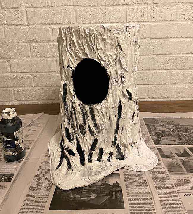 paint recessed areas of paper mache with black gesso