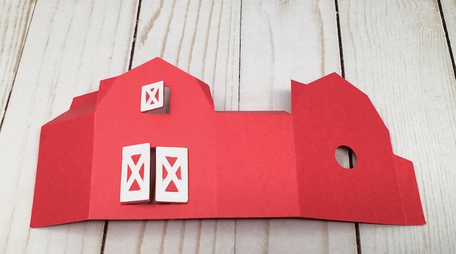 small red paper barn with door frame glued on